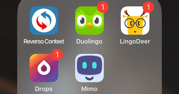 An iOS app-drawer containing icons for the educational apps Reverso Context, Duolingo, LingoDeer, Drops and Mimo.